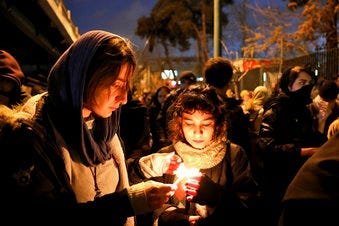 eople gather for a candlelight vigil to remember the victims of the Ukraine plane crash, at the gate of Amri Kabir University that some of the victims of the crash were former students of, in Tehran, Iran. (AP Photo/Ebrahim Noroozi)