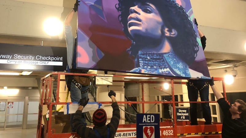 A mural of Prince being installed at MSP