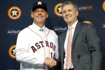 FILE - In this Sept. 29, 2014, file photo, Houston Astros general manager Jeff Luhnow, right, and A.J. Hinch pose after Hinch is introduced as the new manager of the baseball club in Houston. (AP Photo/Pat Sullivan, File)