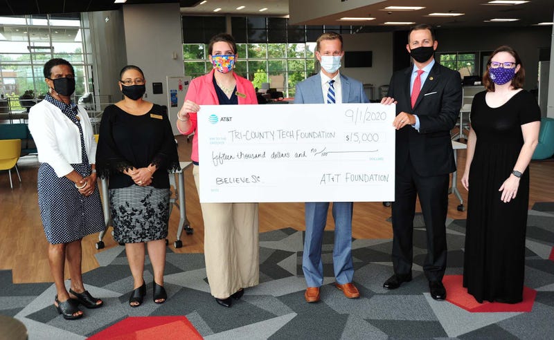 Amanda Taylor Giving the Donation to Tri-County Technical College