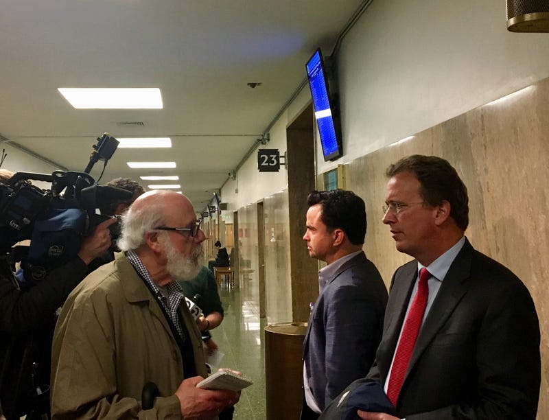 Attorney Thomas Burke, right, answers questions about his client Bryan Carmody, a freelance journalist whose home and office were raided by San Francisco police.