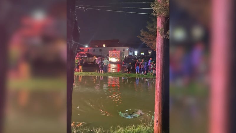 Emergency and rescue crews near a flooded roadway in Avondale, PA.