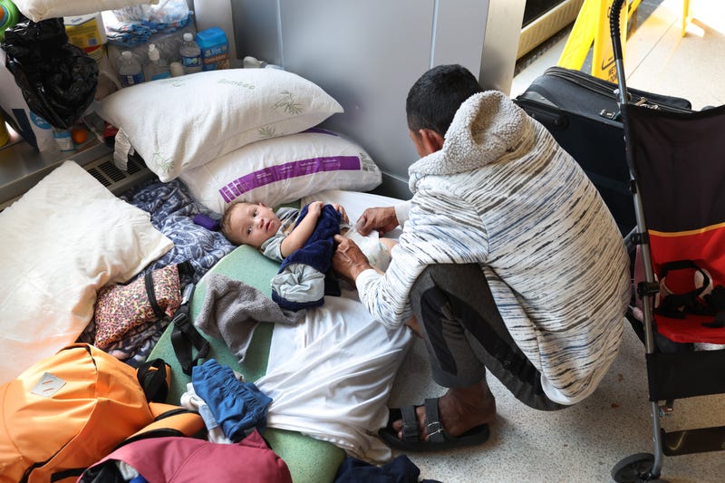 migrant and baby at Chicago police lobby