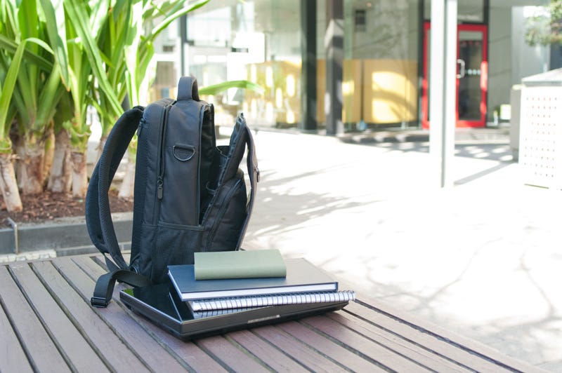 Student's backpack, laptop and books on a seat