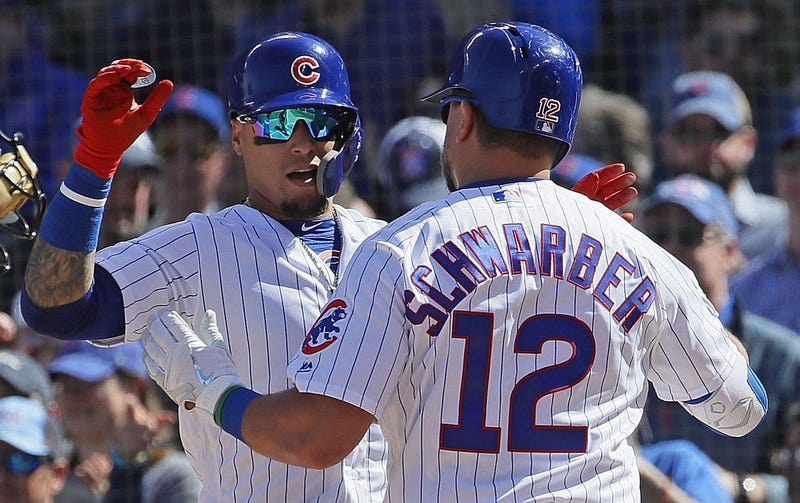 Kyle Schwarber is greeted by Cubs teamamte Javier Baez after homering against the Pirates.