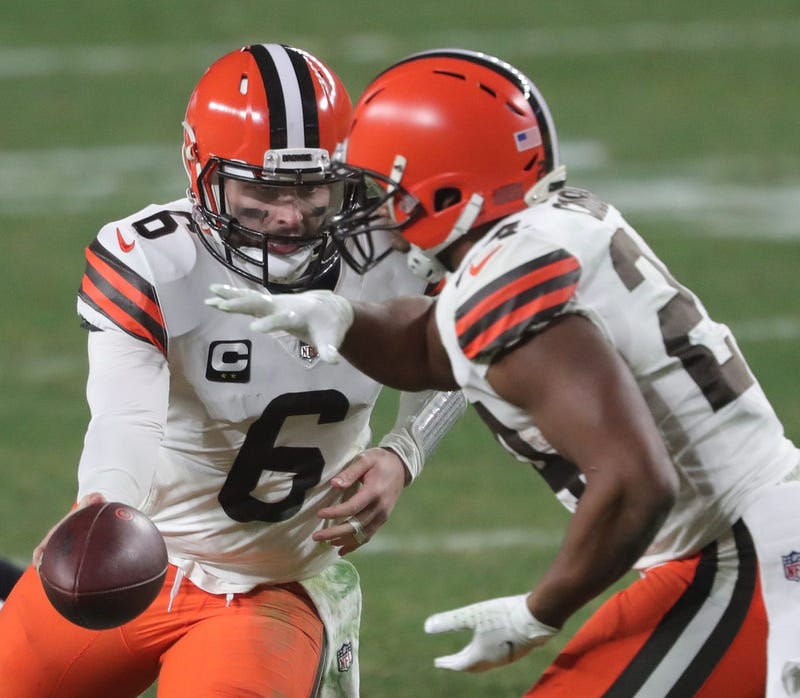 Cleveland Browns quarterback Baker Mayfield hands the ball off to Cleveland Browns running back Nick Chubb during the second half of an NFL wild-card playoff football game, Sunday, Jan. 10, 2021, in Pittsburgh, Pennsylvania.