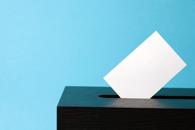 ballot box with voting paper in hole