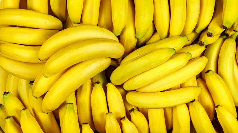 Background of many banana pieces, overhead view, studio food photography. Macro