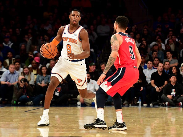 RJ Barrett looks to dribble past a defender.