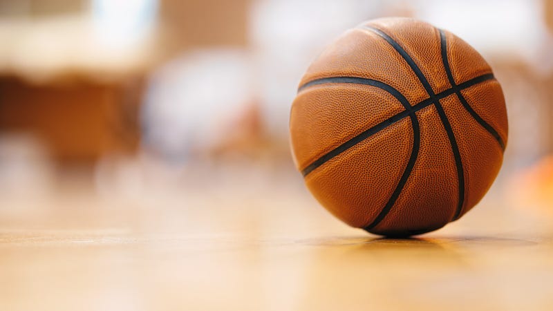 Close-up image of basketball ball over floor in the gym