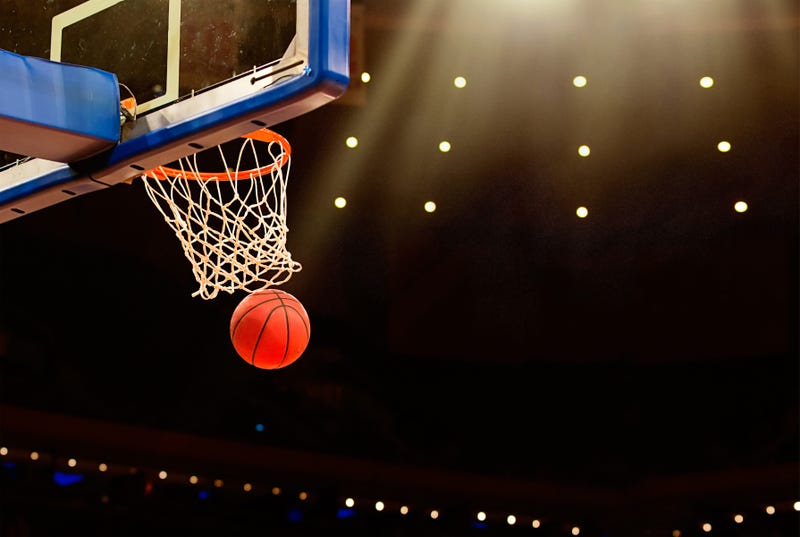 Basketball basket with ball going through net