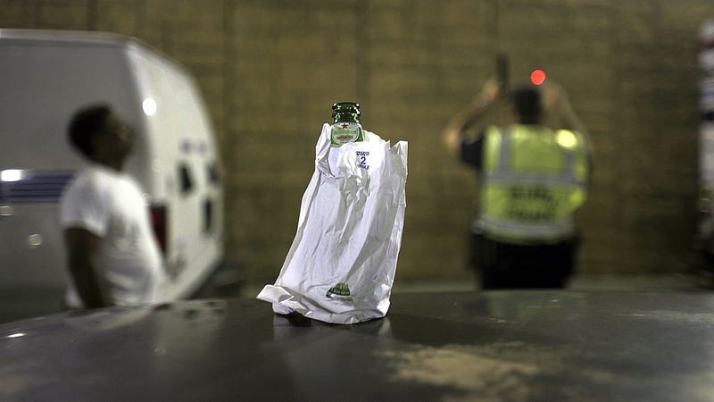 A bottle of beer sits on the roof of a car at a DUI checkpoint December 15, 2006 in Miami, Florida.
