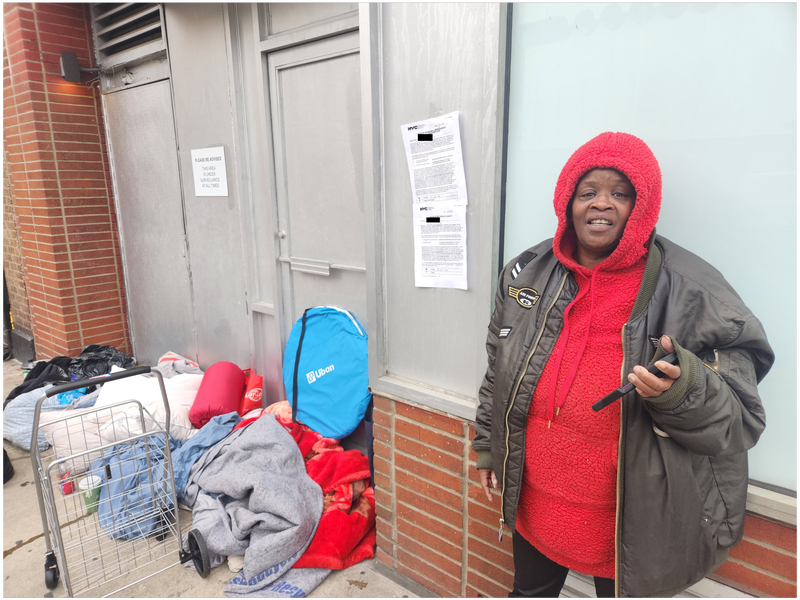 Vails stands in front of her belongings and the sign posted by the city notifying her of the coming sweep.