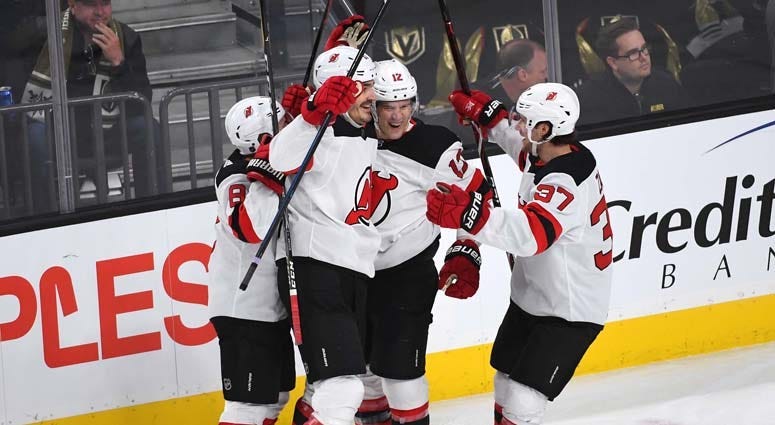 Devils defenseman Ben Lovejoy (12) celebrates with teammates after scoring a first period goal against the Vegas Golden Knights on Jan. 6, 2019, at T-Mobile Arena in Las Vegas.