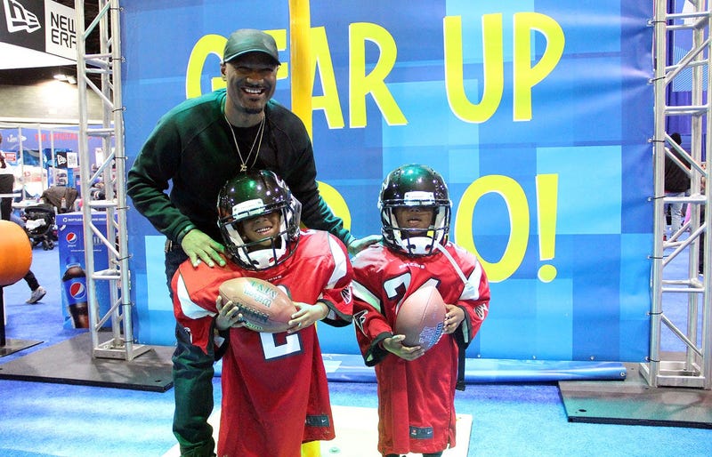 Big Tigger with kids in oversized Falcons uniforms