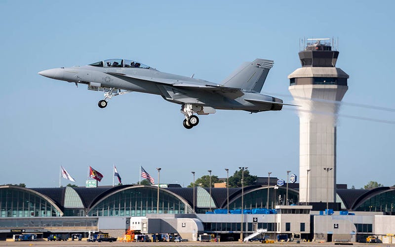 The F/A-18 Block III Super Hornet takes off from a runway at St. Louis-Lambert International Airport