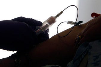 FILE - In this April 28, 2015 file photo, a patient has her blood drawn for a liquid biopsy at a hospital in Philadelphia. (AP Photo/Jacqueline Larma)