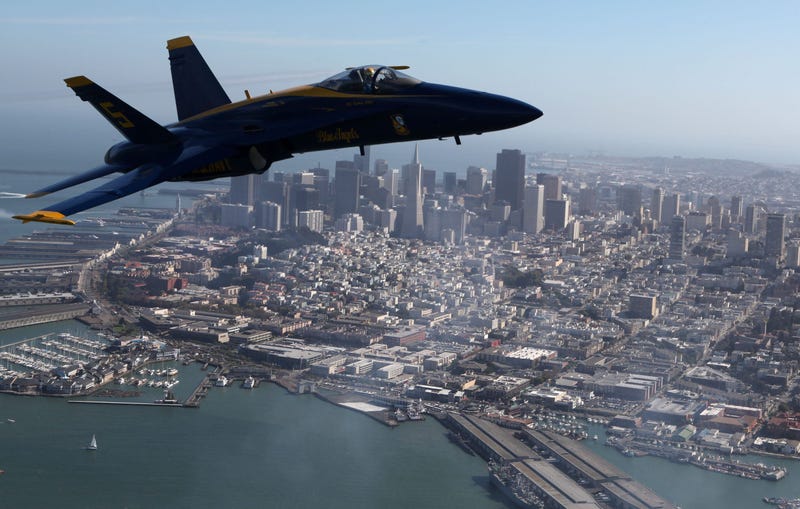 A U.S. Navy Blue Angels F/A-18 Hornet piloted by U.S. Marine Corps Major Nathan Miller flies over the San Francisco skyline during a practice flight in Fleet Week 2009.