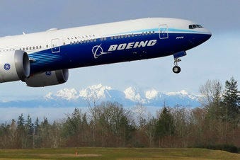 FILE - In this Jan. 25, 2020, file photo a Boeing 777X airplane takes off on its first flight with the Olympic Mountains in the background at Paine Field in Everett, Wash. (AP Photo/Ted S. Warren, File)