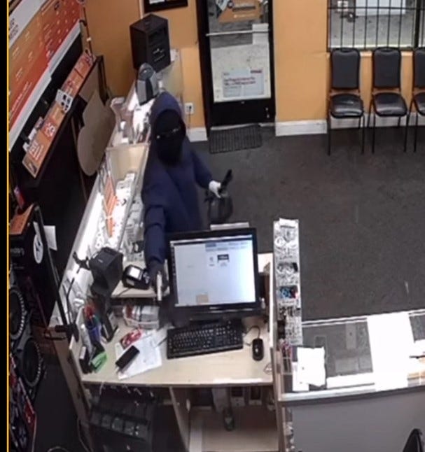 Boost Mobile robber holding gun