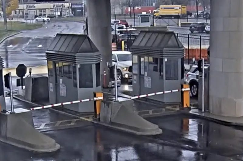 In this photo taken from security video, a light colored vehicle, top left, travels toward the Rainbow Bridge customs plaza, Wednesday, Nov. 22, 2023, in Niagara Falls, N.Y. A vehicle exploded at a checkpoint on the American side of a U.S.-Canada bridge in Niagara Falls Wednesday, leaving two people dead and prompting the closing of four border crossings in the area, authorities said.