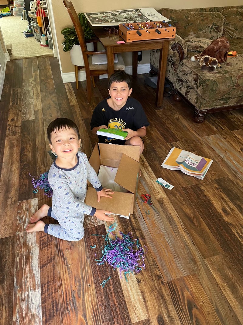 Members of the Boys and Girls Clubs of Contra Costa smile with their boxes of projects.