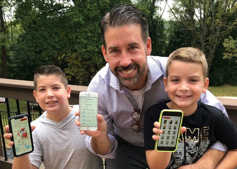 Brad Line of Villanova and his sons, Grayson and Nolan, showing off their app, Squishr, for tracking spotted lanternflies.