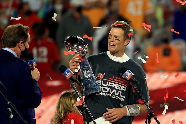 Tom Brady hoists the Lombardi Trophy