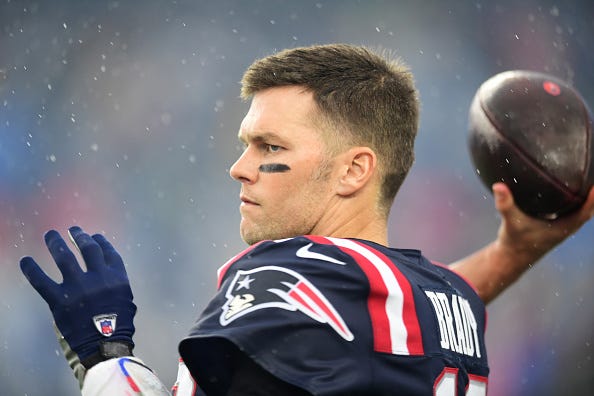 Tom Brady warms up in the rain at Gillette Stadium. 