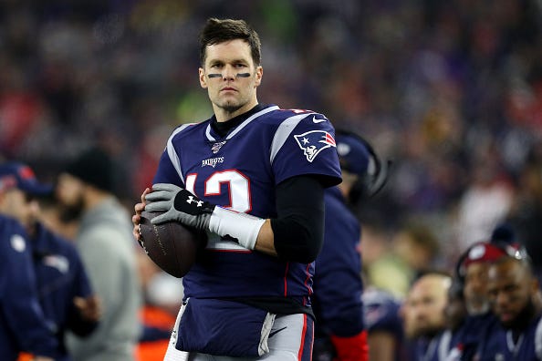 Tom Brady warms up before a playoff game for the Patriots