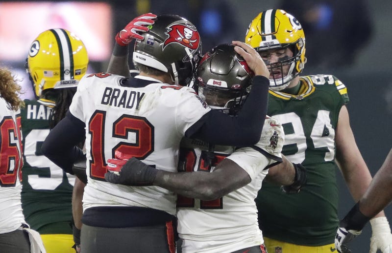 Tampa Bay Buccaneers quarterback Tom Brady celebrates with running back Ronald Jones after defeating the Green Bay Packers during the NFC championship game Sunday, January 24, 2021, at Lambeau Field