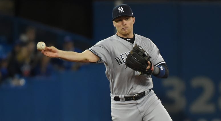 Yankees third baseman Brandon Drury throws to first base to force out the Blue Jays' Randal Grichuk on April 1, 2018, at Rogers Centre in Toronto.
