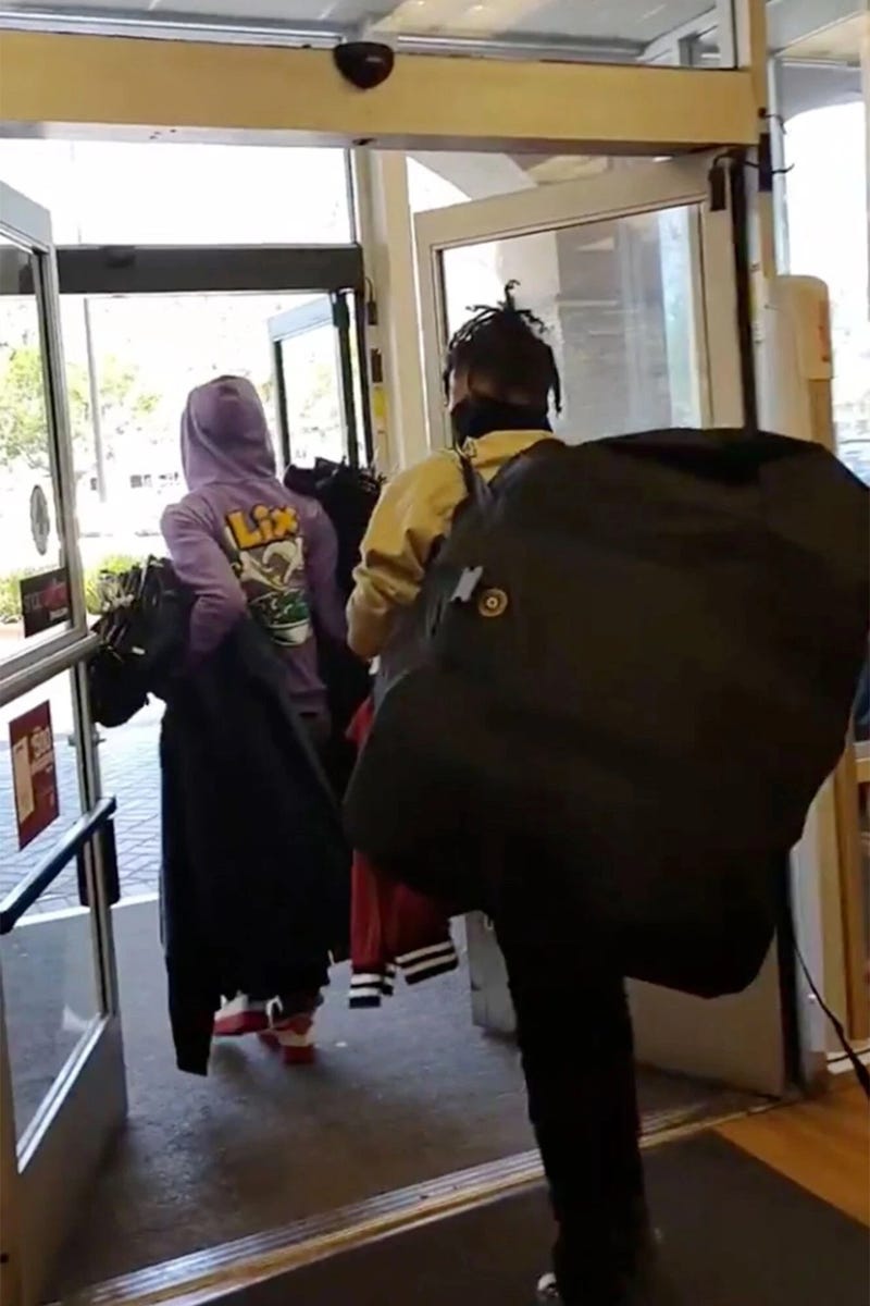 Two shoplifters brazenly walk out with armfuls of items