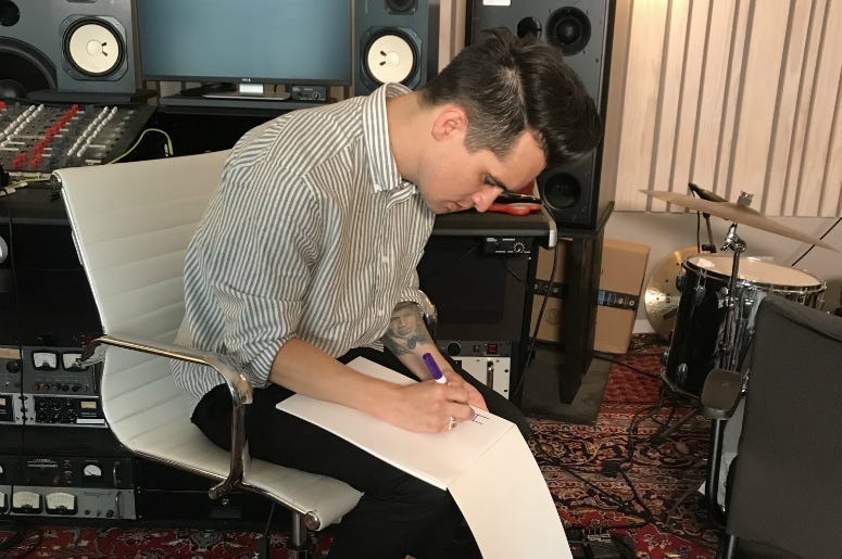 Brendon Urie from Panic! At The Disco drawing a mystery billboard