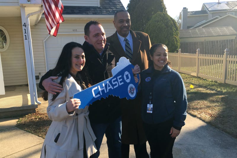 Brett Dawson, with his fiancée at far left, stands with representatives from J.P. Morgan Chase and Operation Homefront.