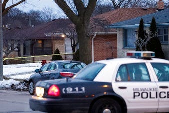 Police are seen outside of a house near Potomac and Courtland after a shooting at Molson Coors, Wednesday Feb. 26, 2020, in Milwaukee. (AP Photo/Morry Gash)