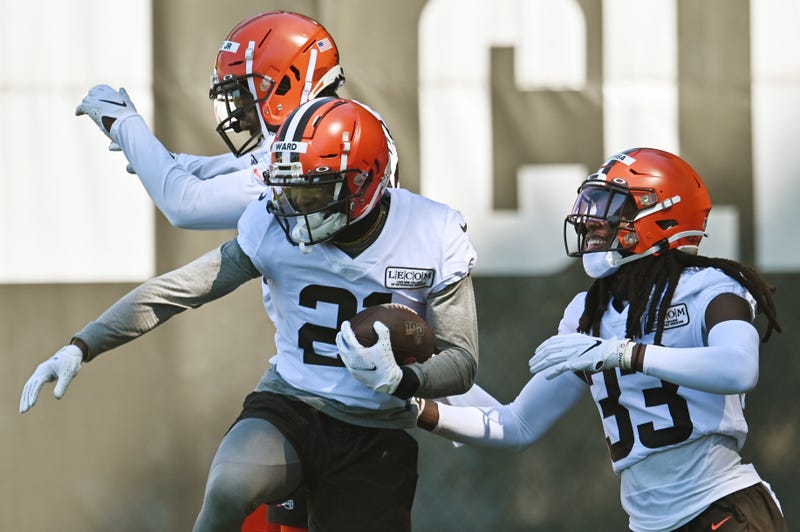 Cleveland Browns cornerback Denzel Ward (21) celebrates with cornerback Donnie Lewis Jr. (37) and cornerback Donovan Olumba (33) after an interception during training camp at the Cleveland Browns training facility.