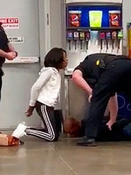 In this March 23, 2020 frame grab taken from video, Marvia Gray, is seen on her knees, while her son Derek Gray is seen face down as they are arrested at a Sam's Club store in Des Peres, Missouri. ( Photo courtesy Action Injury Law Group via AP)