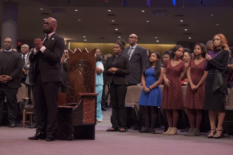 Bryant's ex-wife and their 3 daughters sit behind him during Sunday evening's Installation Service
