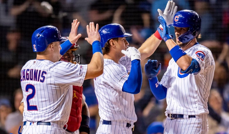 Cubs third baseman Kris Bryant (right) celebrates with teammates after hitting a grand slam against the Cardinals.