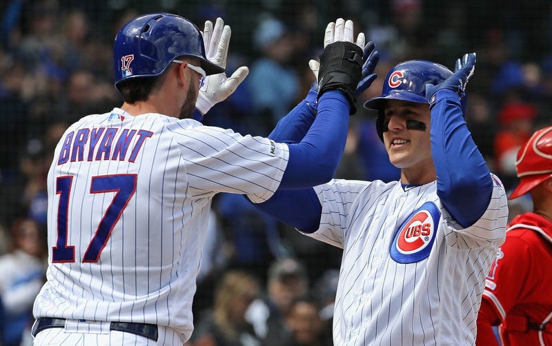 Kris Bryant (17) congratulates Cubs teammate Anthony Rizzo after Rizzo homered.