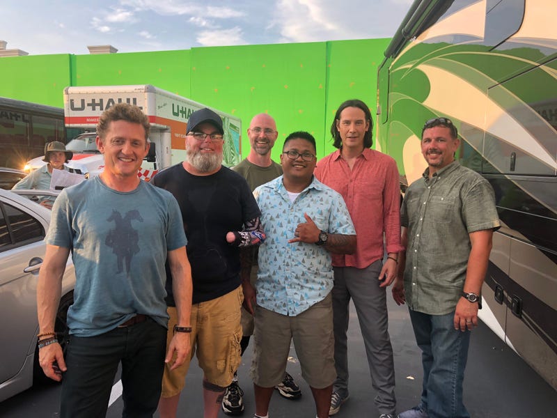 Military veterans pose with actors Keanu Reeves, Bill Winter on the set of the new Bill and Ted movie