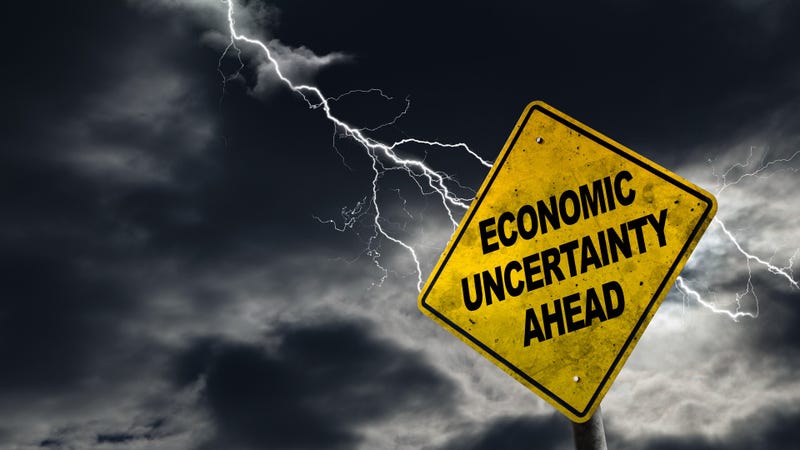 Economic Uncertainty Ahead sign with stormy background - stock photo