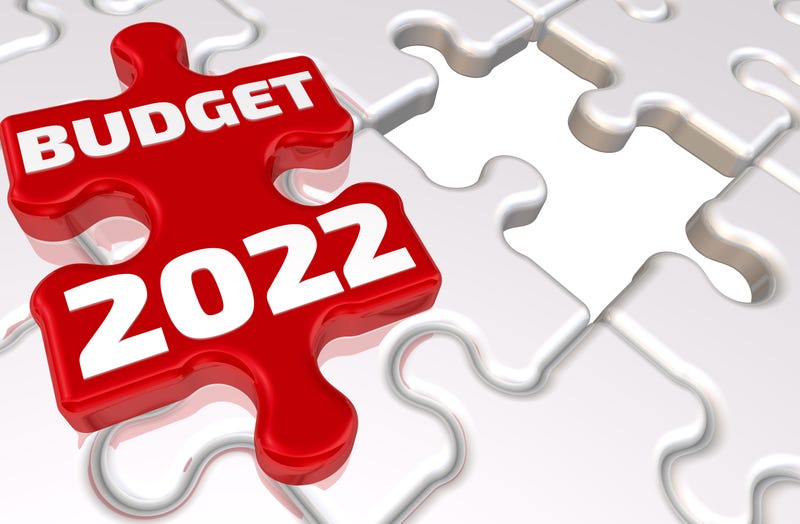 Folded white puzzles elements and one red with white text BUDGET 2022