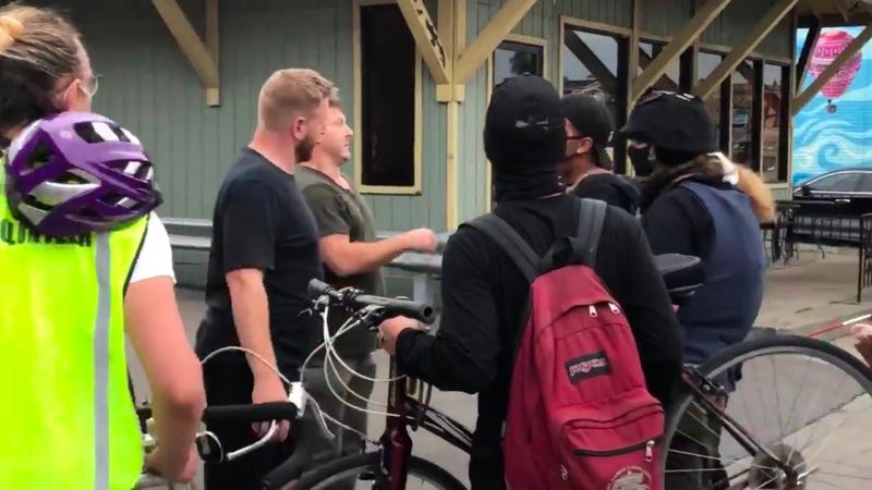 Two men, one of whom allegedly brandishing a knife, confront protesters on Hertel Avenue in Buffalo. August 28, 2020 (WBEN Photo/Brendan Keany)