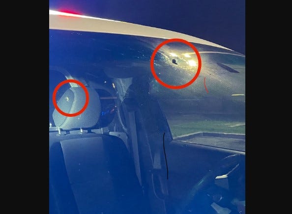 The police vehicle was hit in the windshield and headrest.
