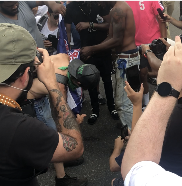 Protestors burn the pro-mounment flag of a counter protestor on July 1, 2020. (Matt Demlein, WRVA)