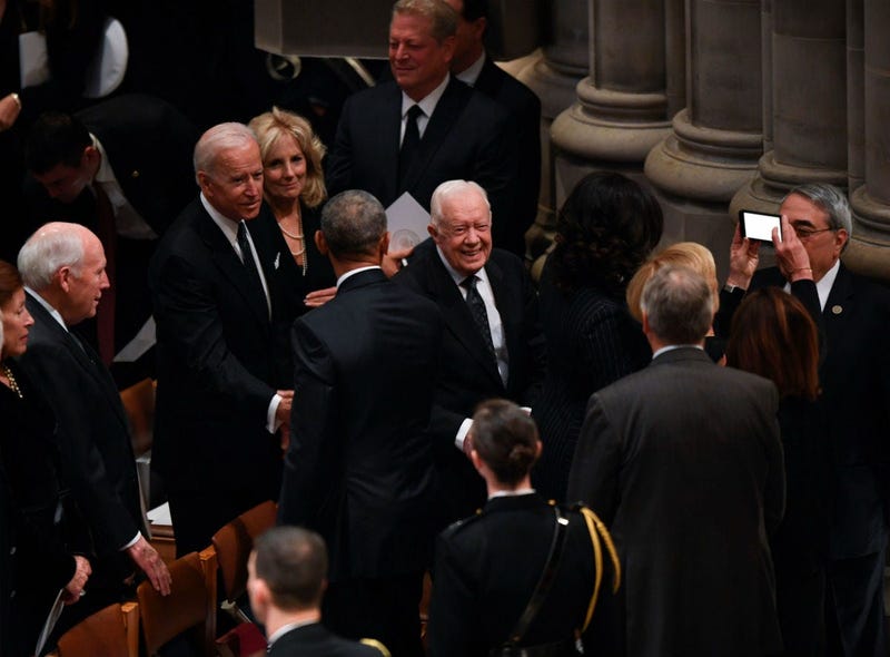 Former President Jimmy Carter and former Vice President Joe Biden arrive at a state funeral for former President George H.W. Bush at the Washington National Cathedral, in Washington, Dec. 5, 2018.