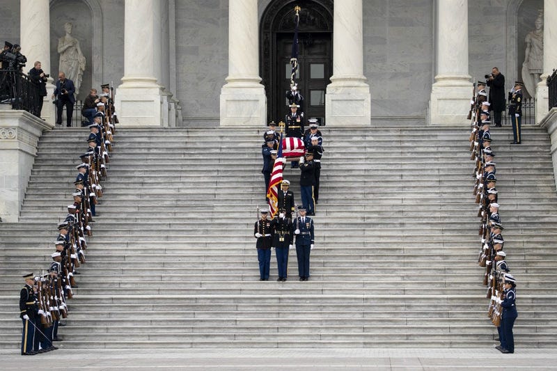 A U.S. military honor guard carries the flag-draped casket of the late former President George H.W. Bush down the steps of the U.S. Capitol, December 5, 2018 in Washington, DC.