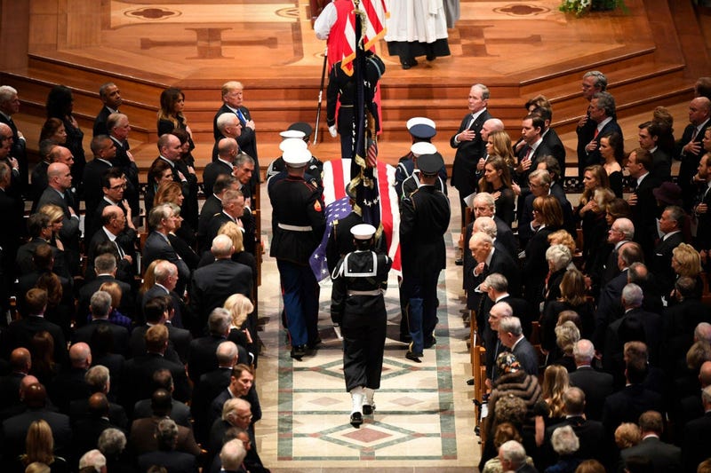 The flag-draped casket of former President George H.W. Bush is carried by a military honor guard during a State Funeral at the National Cathedral, Wednesday, Dec. 5, 2018, in Washington.